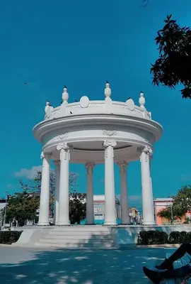 a large white building with pillars in front of it at Cienaguas Hotel in Ciénaga