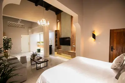 a bedroom with a white bed and a couch at Scalea Di Mare Hotel in Cartagena de Indias