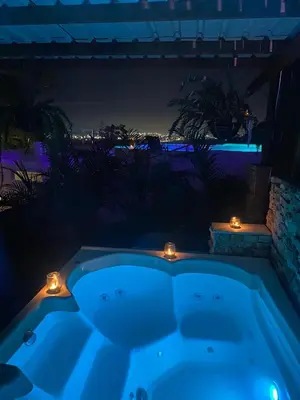 a hot tub in a backyard at night with lights at ADA MARINA, hotel campestre con la mejor vista a Cartagena in Turbaco