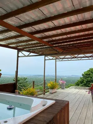 a hot tub on a wooden deck with a roof at ADA MARINA, hotel campestre con la mejor vista a Cartagena in Turbaco