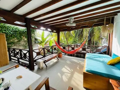 a room with a hammock on a balcony at Quatro palos in Rincón