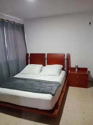 a bedroom with a large bed with a wooden frame at Apartamento mar in Cartagena de Indias