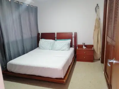 a bedroom with a bed with a wooden headboard at Apartamento mar in Cartagena de Indias