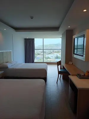 a hotel room with two beds and a window at Wyndham Garden Cartagena in Cartagena de Indias