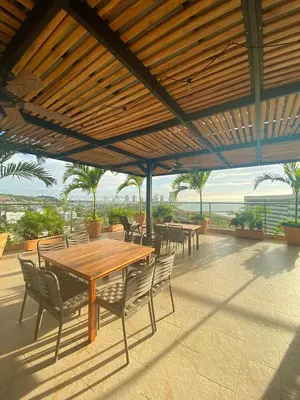 a patio with tables and chairs and a view of the ocean at Wyndham Garden Cartagena in Cartagena de Indias