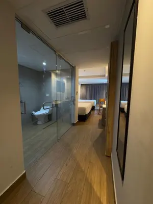 a room with a glass door leading to a bedroom at Wyndham Garden Cartagena in Cartagena de Indias
