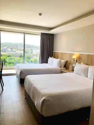 two beds in a hotel room with a large window at Wyndham Garden Cartagena in Cartagena de Indias