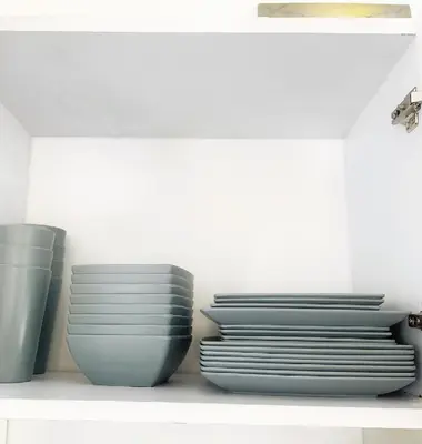 a group of plates and bowls sitting on a shelf at ARMANI in Puerto Colombia