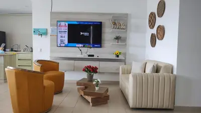 a living room with a couch and a tv on a wall at Cabaña Apartamento En Coveñas - Fontaine Bleu in Coveñas