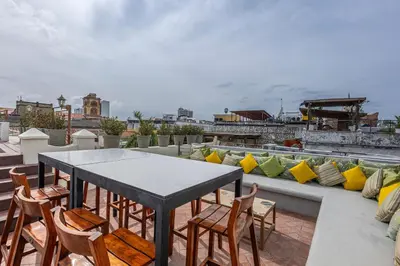 a patio with a table and chairs on a roof at Ananda Hotel Boutique in Cartagena de Indias