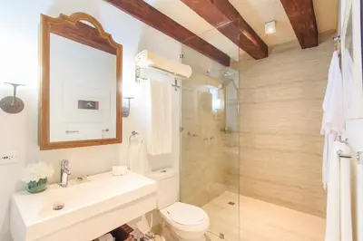 a bathroom with a sink and a toilet and a shower at Hotel Boutique Casa del Coliseo in Cartagena de Indias