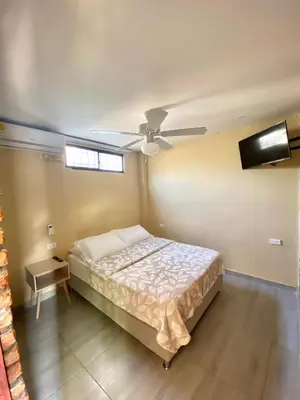 a bedroom with a bed and a ceiling fan at Apartaestudios - Casa Tamarindo in Aracataca
