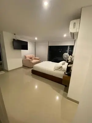 a bedroom with a bed and a television in it at Apto- Condominio H Sonesta - Morros-salida a la playa - cerca Hotel Americas in Cartagena de Indias