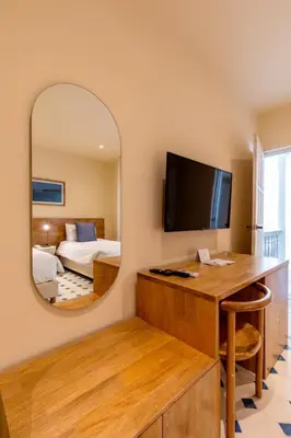 a hotel room with a large mirror and a bedroom at B Haus Hotel Boutique in Cartagena de Indias