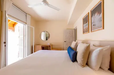 a bedroom with a large white bed with pillows at B Haus Hotel Boutique in Cartagena de Indias