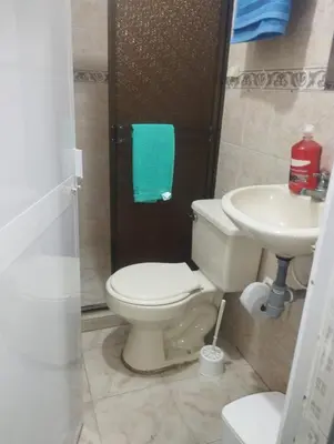 a bathroom with a toilet and a sink at Apartamentos San Felipe in Cartagena de Indias