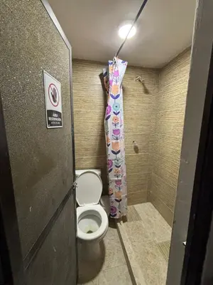 a bathroom with a toilet and a shower curtain at Apartamentos San Felipe in Cartagena de Indias