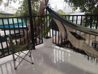 a hammock and a chair on a balcony at Apartamentos San Felipe in Cartagena de Indias