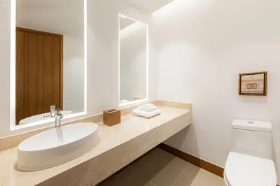 a white bathroom with a sink and a toilet at Barranquilla Marriott Hotel in Barranquilla