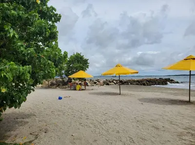 a beach with yellow umbrellas and people on the sand at Apartamento con VISTA AL MAR, A una cuadra de la PLAYA. Piso 16 in Cartagena de Indias