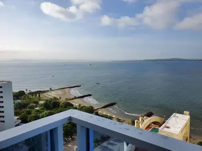 a view of the beach from the balcony of a building at Apartamento con VISTA AL MAR, A una cuadra de la PLAYA. Piso 16 in Cartagena de Indias