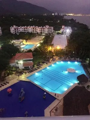 an overhead view of a large swimming pool at night at Costa Azul Suite 804 in Santa Marta