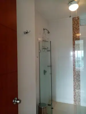 a shower with a glass door in a bathroom at Costa Azul Suite 804 in Santa Marta