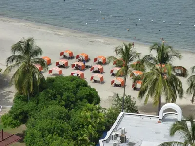 an overhead view of a beach with chairs and umbrellas at Costa Azul Suite 804 in Santa Marta