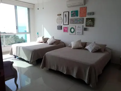 two beds sitting next to each other in a bedroom at Costa Azul Suite 804 in Santa Marta