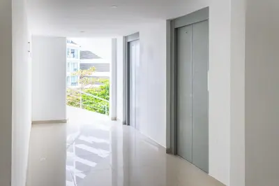 a hallway with white walls and white floors and sliding doors at 1 Bedroom Apartment Morros. Beach access in Cartagena de Indias