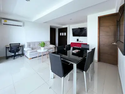a dining room and living room with a table and chairs at 1 Bedroom Apartment Morros. Beach access in Cartagena de Indias