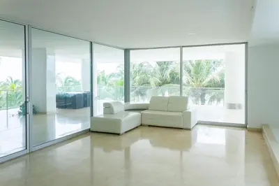 a living room with white furniture and large windows at 1 Bedroom Apartment Morros. Beach access in Cartagena de Indias