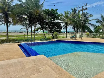 a blue swimming pool with a view of the beach at 1 Bedroom Apartment Morros. Beach access in Cartagena de Indias