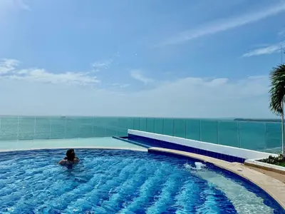 a person in a swimming pool on top of a building at 1 Bedroom Apartment Morros. Beach access in Cartagena de Indias