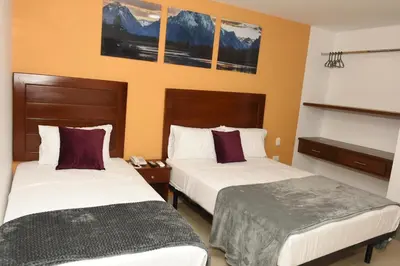 a hotel room with two beds in a room at Hotel Kai Soledad Atlántico in Soledad