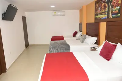 a hotel room with two beds and a flat screen tv at Hotel Kai Soledad Atlántico in Soledad