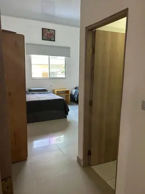 a bedroom with a bed and a sliding door at ALTAVITA apart completo a 100 m del mar in Puerto Colombia
