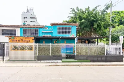 a blue building with a fence in front of it at Ayenda Isla de Manga in Cartagena de Indias