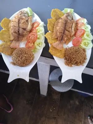 two plates of food with meat and vegetables on them at Hostal azul beach isla baru in Playa Blanca