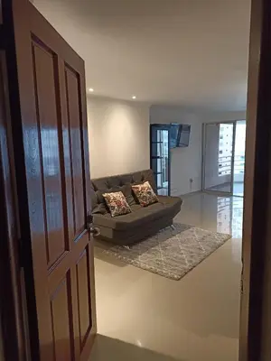 an open door to a living room with a couch at Apartaestudio Altamar in Cartagena de Indias