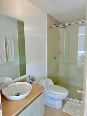 a bathroom with a toilet and a sink and a shower at Artsy Oceanview Condo W Incredible Rooftop Pool in Cartagena de Indias