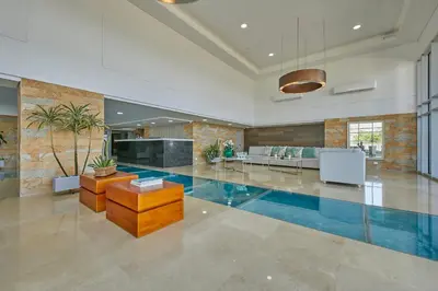 a large room with a swimming pool in a house at Artsy Oceanview Condo W Incredible Rooftop Pool in Cartagena de Indias