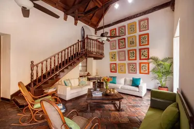 a living room with a staircase and a couch at Casa Baloco in Cartagena de Indias
