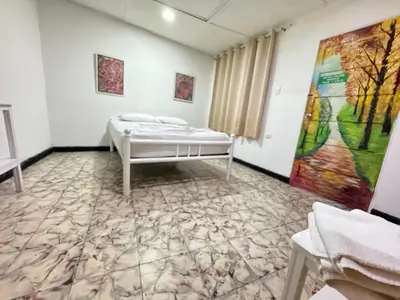 a room with a bed and a painting on the wall at Hostal Luna Llena Getsemaní in Cartagena de Indias