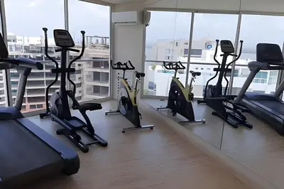 a gym with treadmills and ellipticals in a building at 2 Dormitorios Jacuzzi y Vista Mar. Frente a playa in Cartagena de Indias
