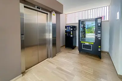 an atm machine in a lobby next to an elevator at 2 Dormitorios Jacuzzi y Vista Mar. Frente a playa in Cartagena de Indias