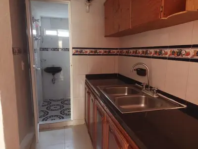 a small kitchen with a sink and a shower at TITTO'S APARTMENT in Cartagena de Indias