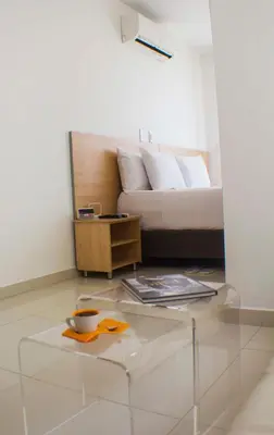 a living room with a couch and a glass coffee table at Hotel Cabreromar in Cartagena de Indias
