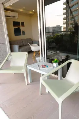 a living room with two white chairs and a table at Confortable y exclusivo apartamento en Martinique Cielo Mar in Cartagena de Indias