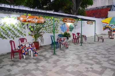a patio with chairs and tables and umbrellas at CASA ZOE in Cartagena de Indias